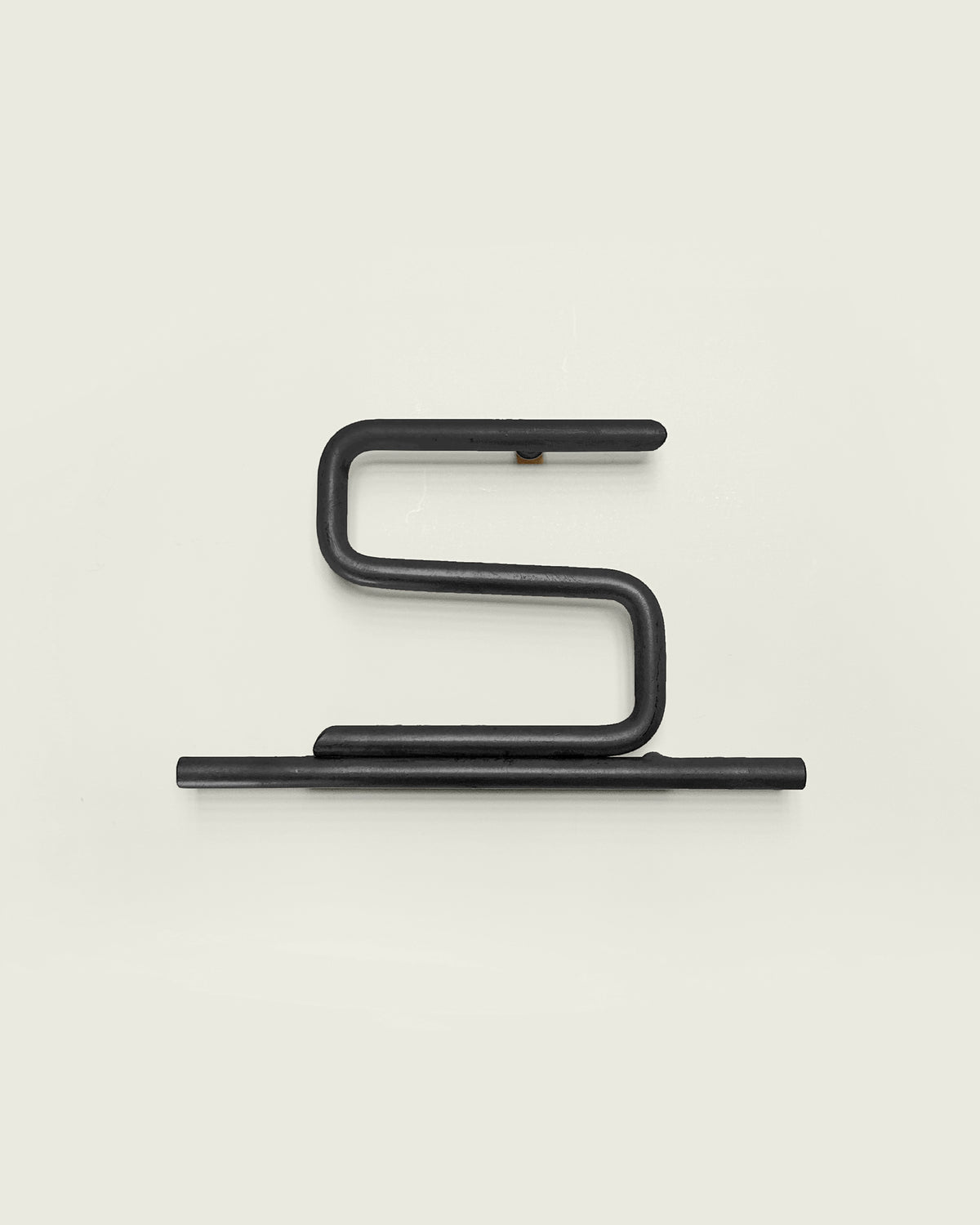 Black house number '5' on a white wall 