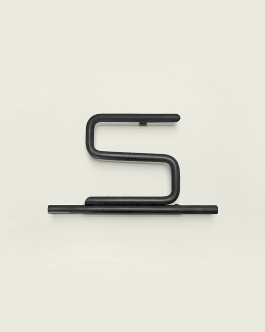 Black house number '5' on a white wall 