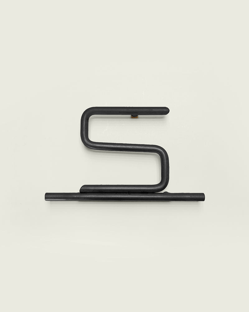 Black house number '5' on a white wall 
