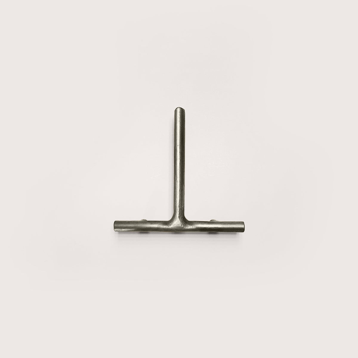 Silver house number '1' on a white wall 