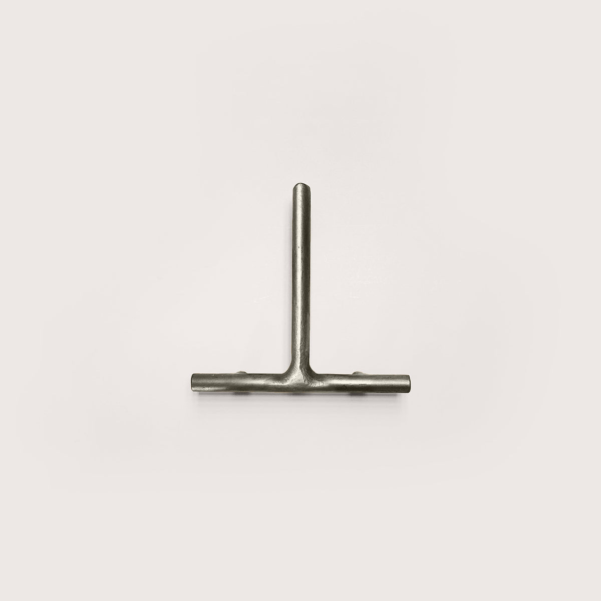 Silver house number '1' on a white wall 