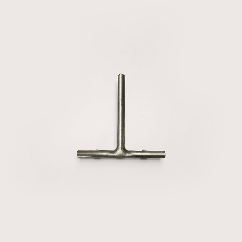 Silver house number '1' on a white wall 