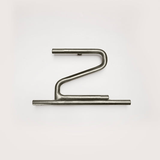 Silver house number '2' on a white wall 