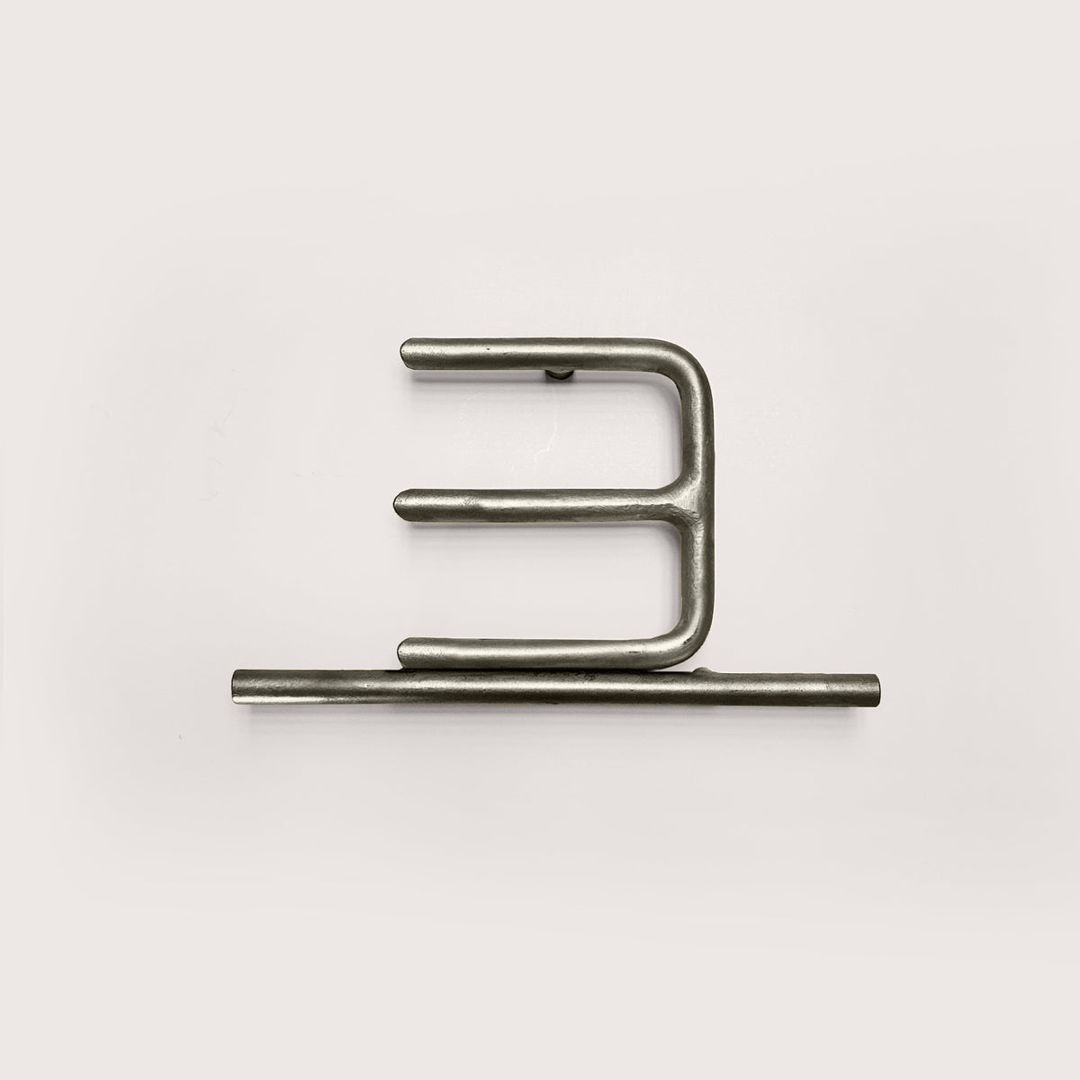 Silver house number '3' on a white wall 