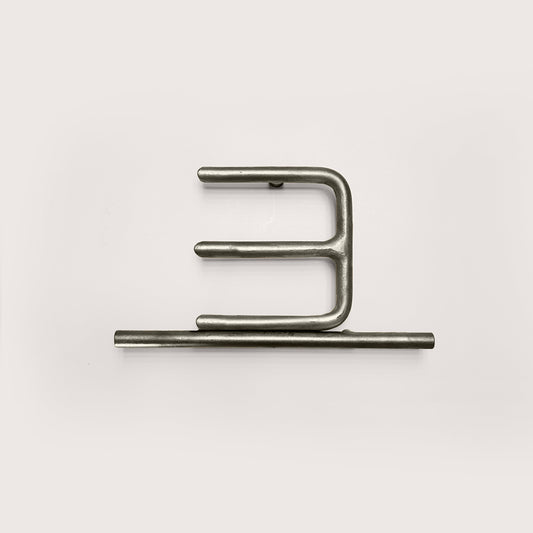 Silver house number '3' on a white wall 