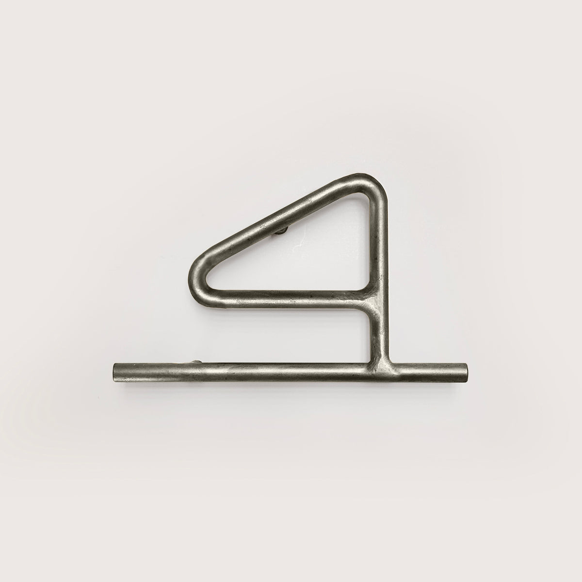 Silver house number '4' on a white wall 