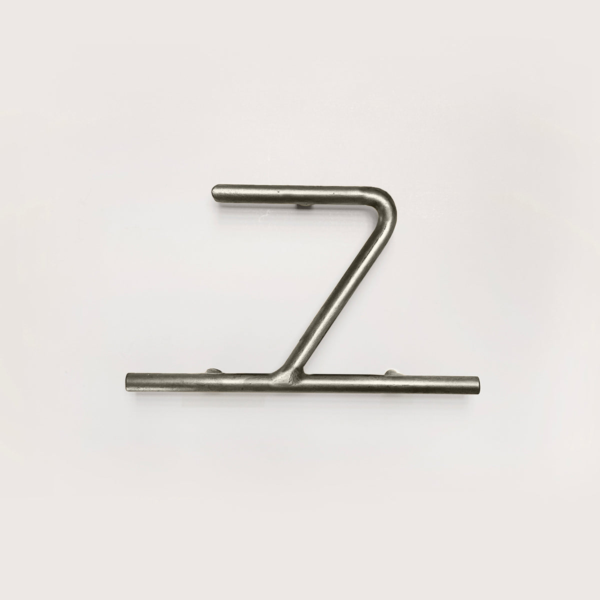 Silver house number '7' on a white wall 