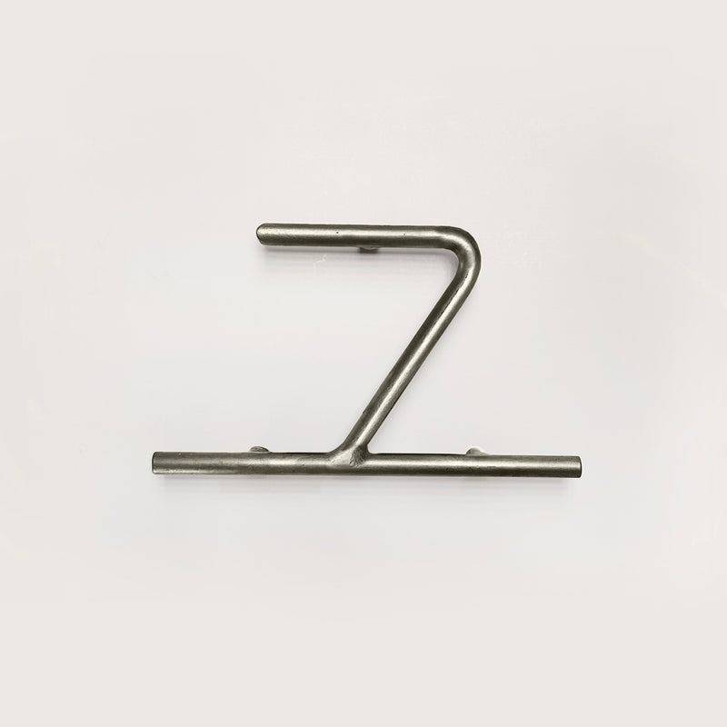 Silver house number '7' on a white wall 