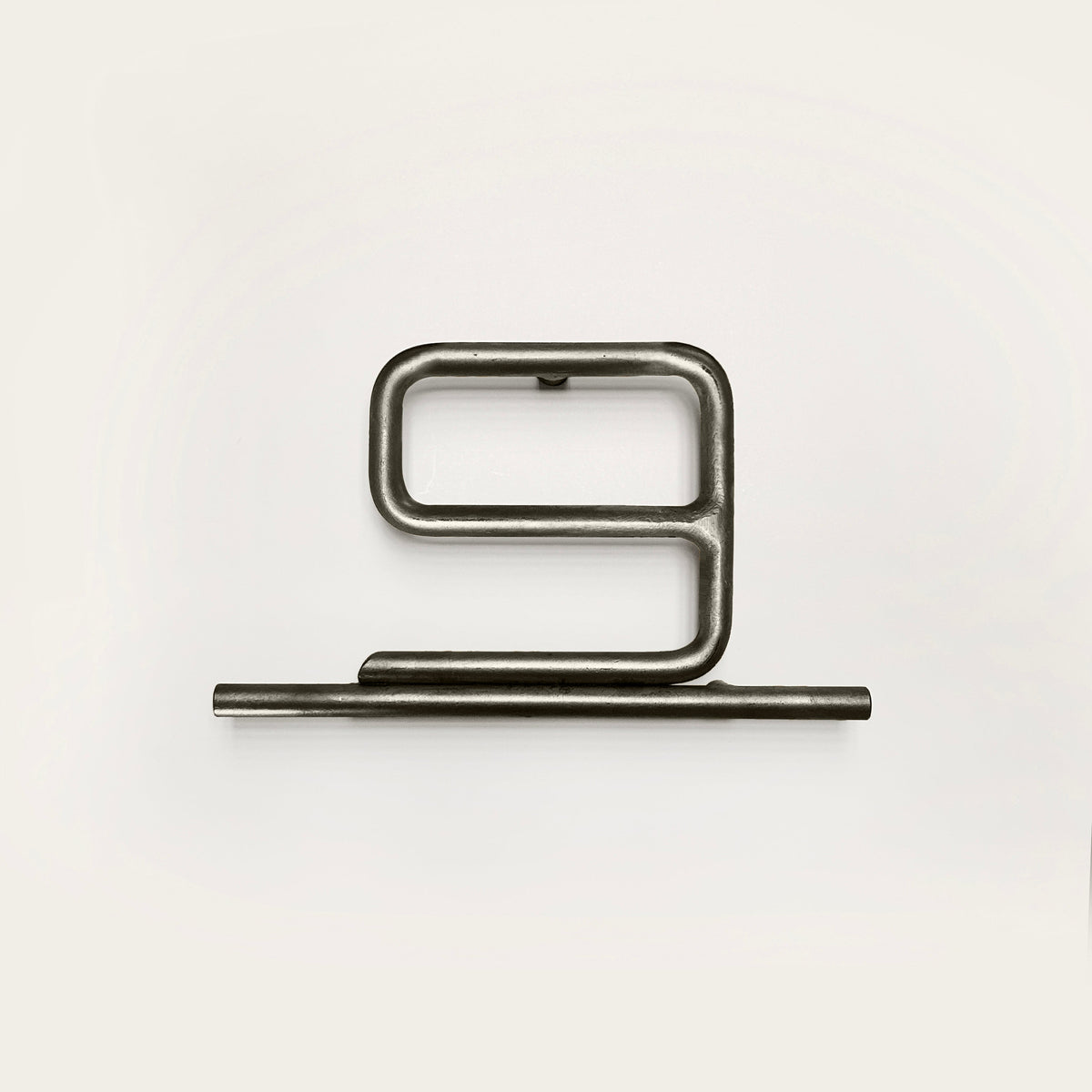 Silver house number '9' on a white wall 
