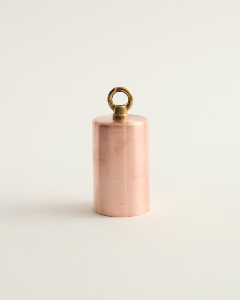 copper pendulum light fixture on white background
