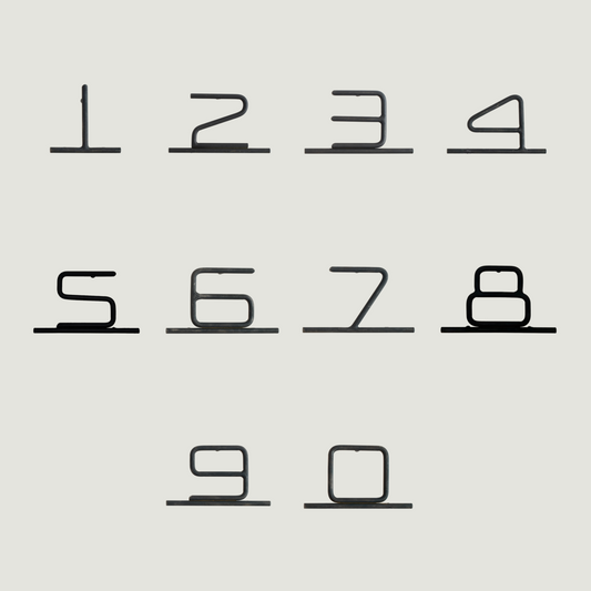 Nine minimalist black metal wire numerals from 0 to 9, arranged in three rows.