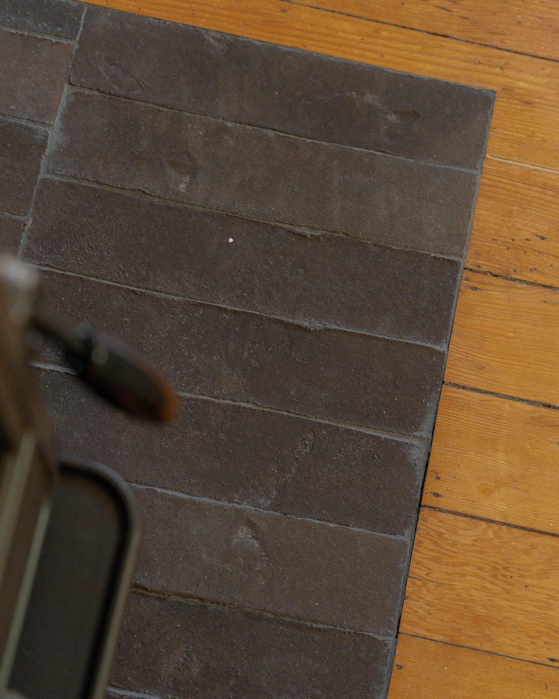 Dark tiles installed by fire place