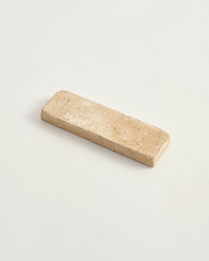 Rectangular worn cotto tile on a light gray background