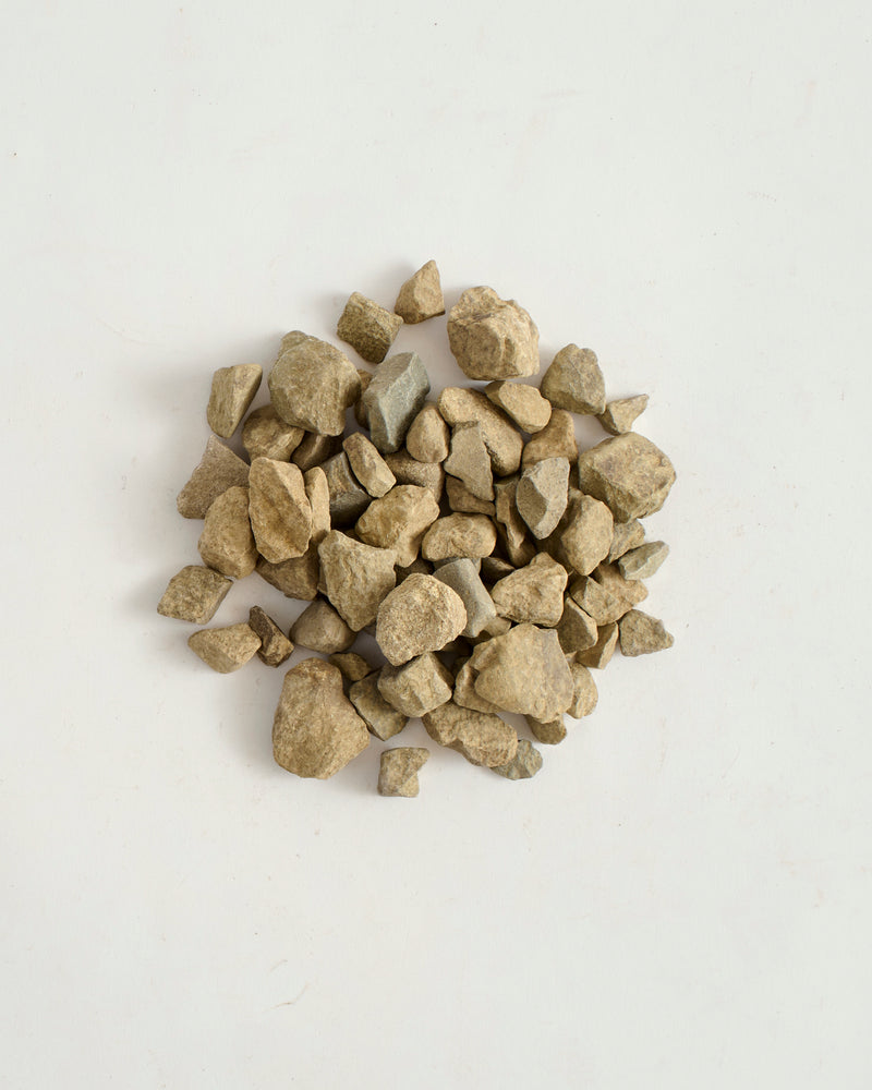 Pile of small stones on a light gray background