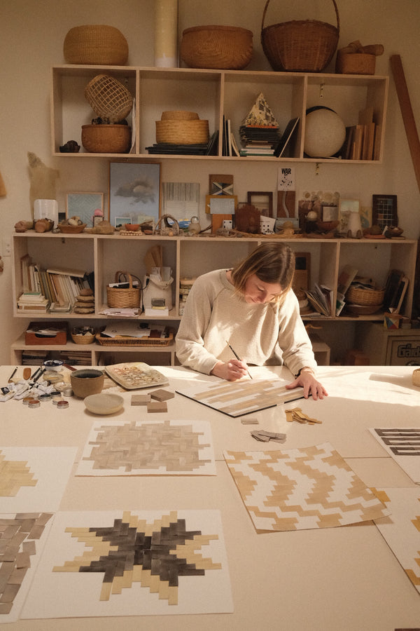 Serena Mitnik-Miller artist painting at a work table
