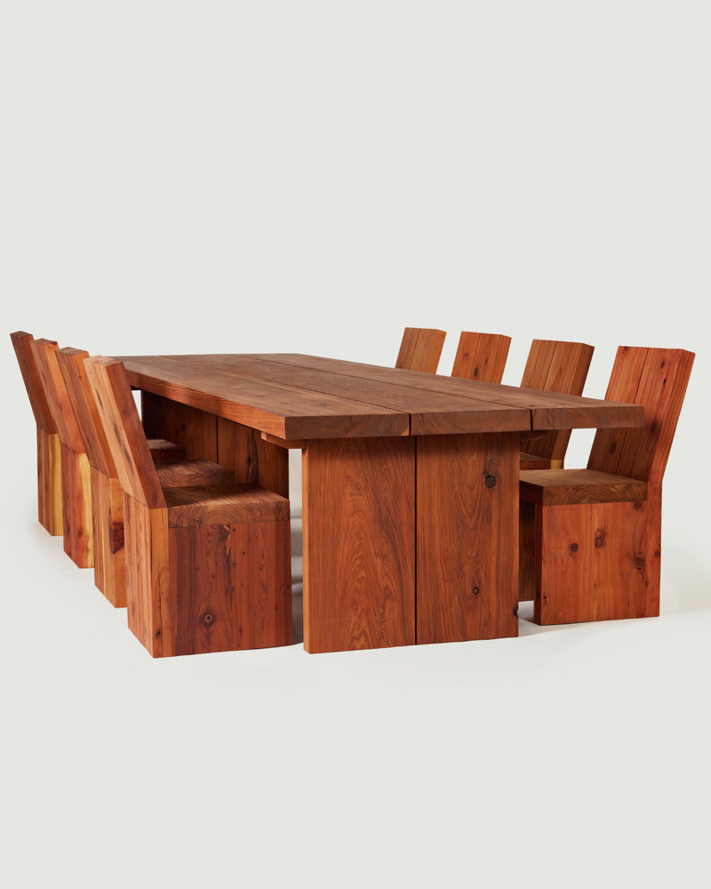 Wooden table with chairs around it. 