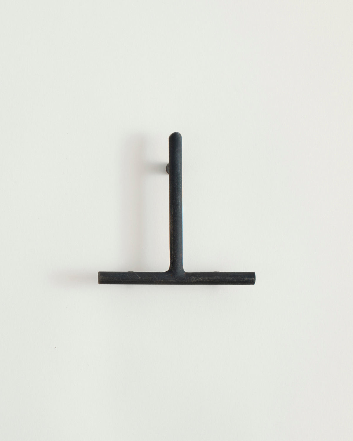Black house number '1' on a white wall 