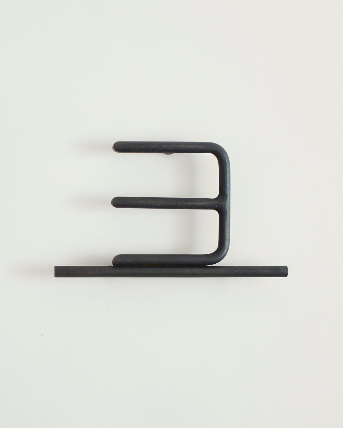Black house number '3' on a white wall 