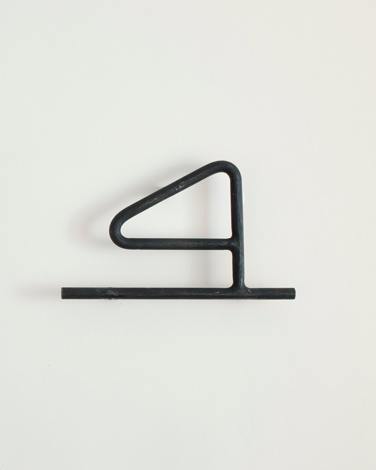 Black house number '4' on a white wall 