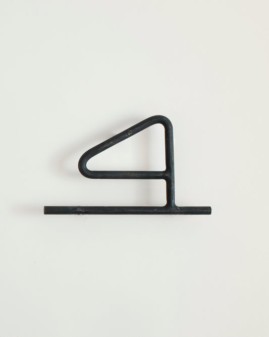 Black house number '4' on a white wall 