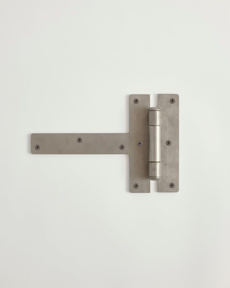 Worn silver hinge on a white background