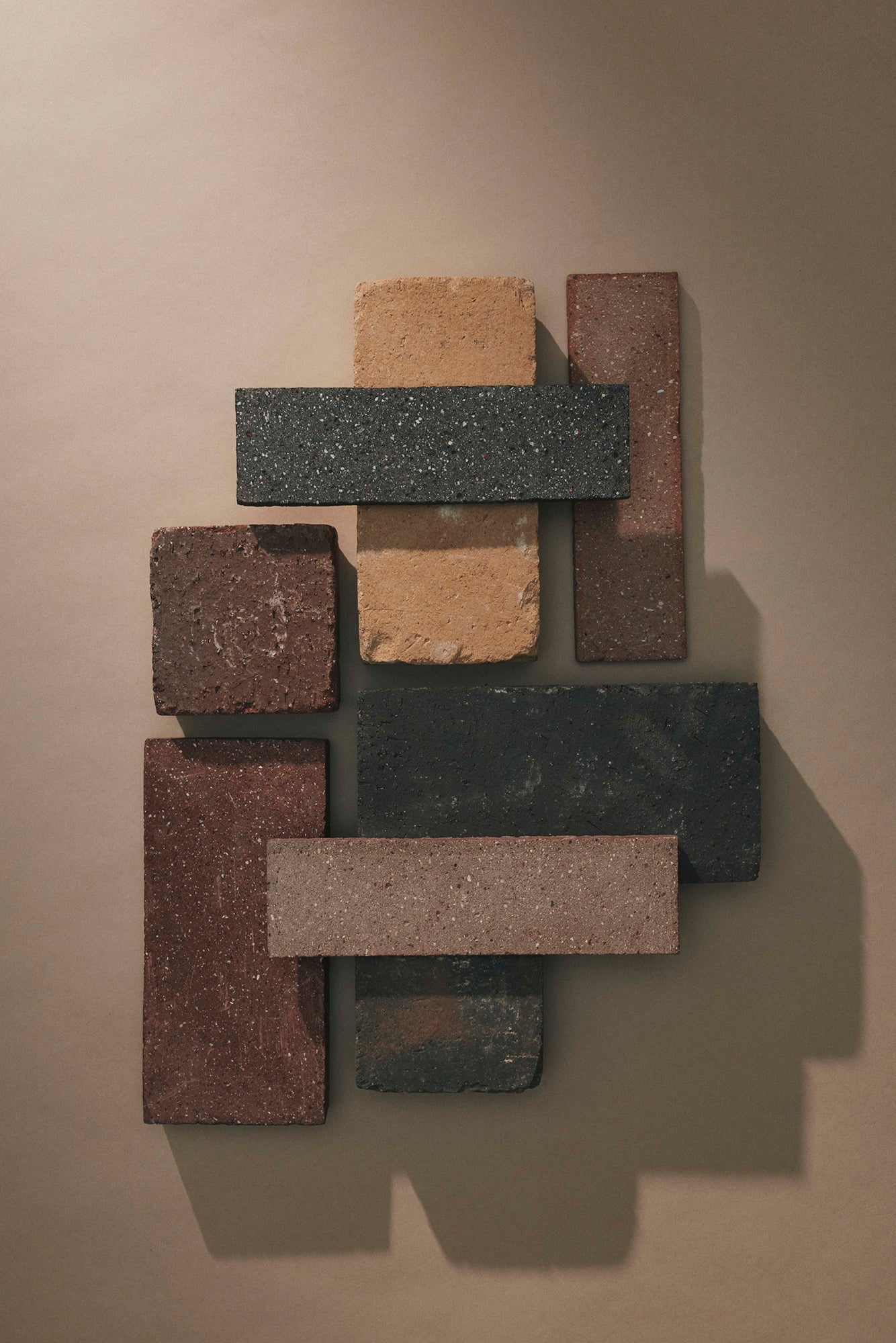 Collection of various stone bricks arranged on a beige background