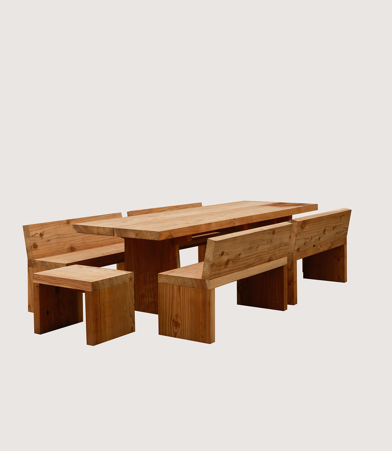 Wooden dining table with benches on a light gray background